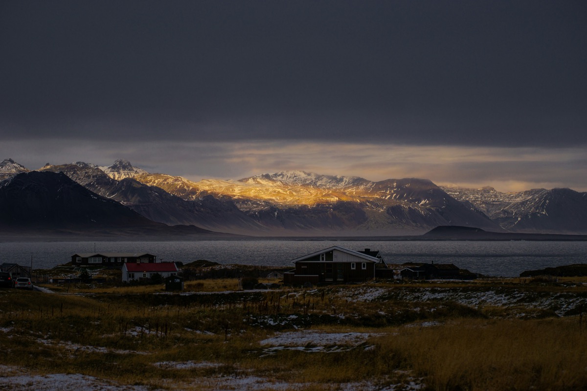 A view of a mountain range with a body of water in the foreground