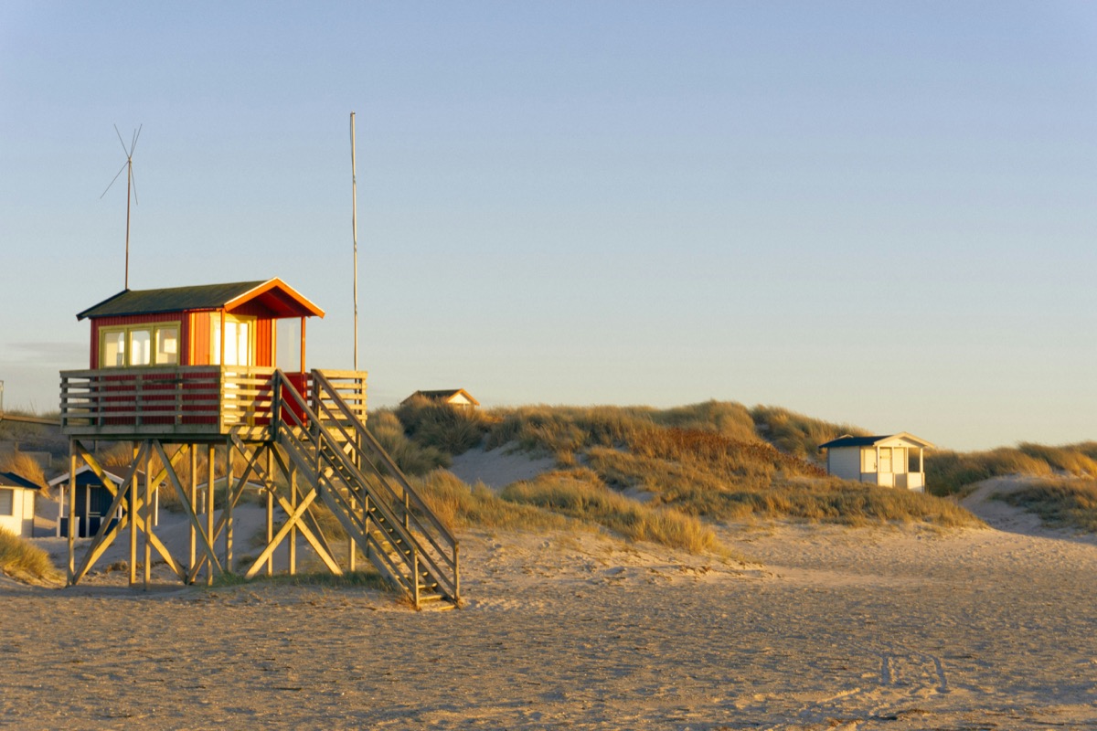 a lifeguard tower on the beach with a life guard