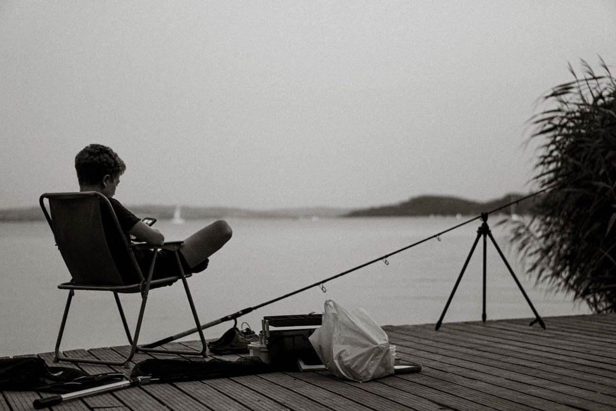 a person sitting in a chair on a dock